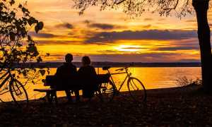 lago tramonto coppia bici